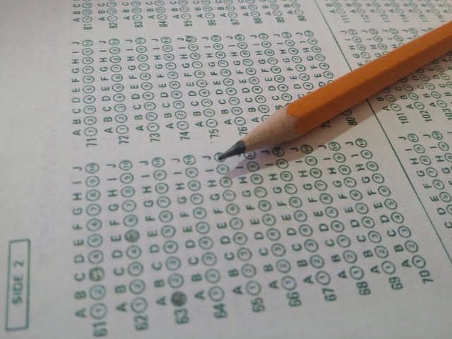 A multiple choice exam answer sheet with a pencil