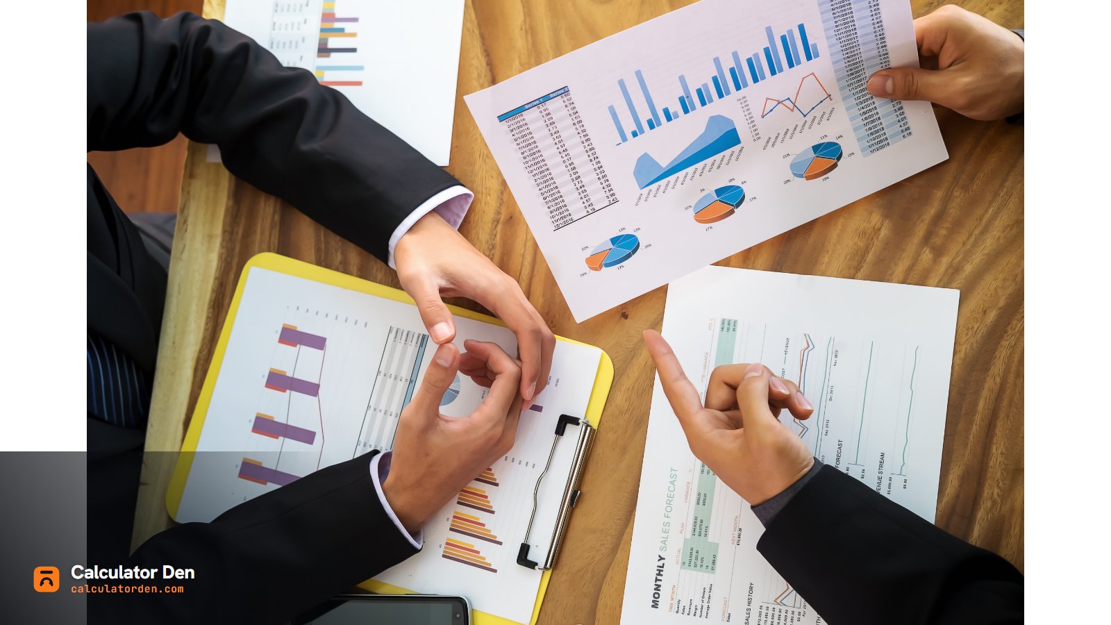 Professionals reviewing financial charts and reports - Calculator Den